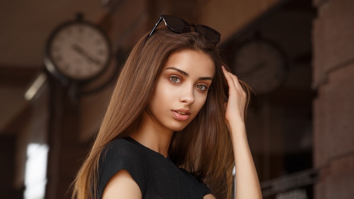 Young woman with sunglasses on head