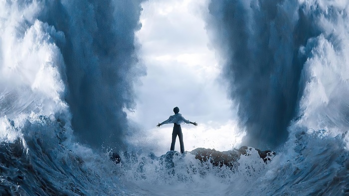 Man standing between parting waves
