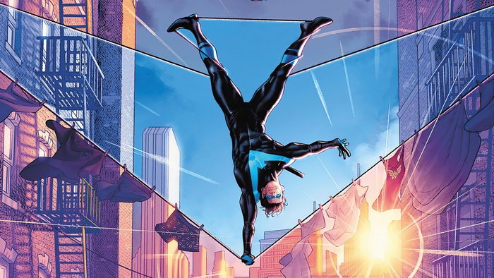 Nightwing performing a handstand on a clothesline