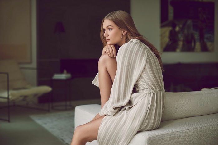 Josephine Skriver sitting on a couch