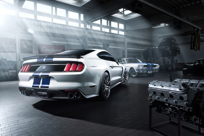 Ford Mustang cars in a garage with engine