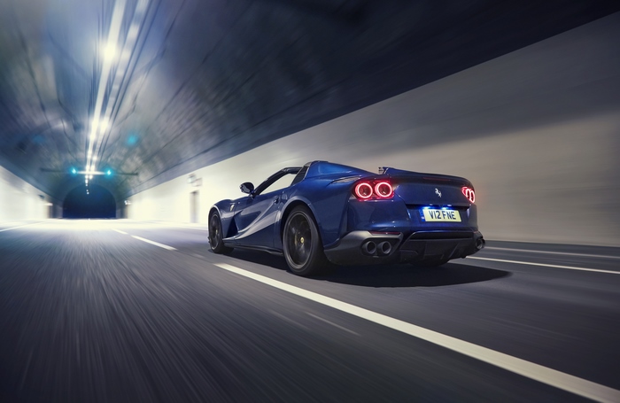 Blue Ferrari 812 Superfast driving through a tunnel