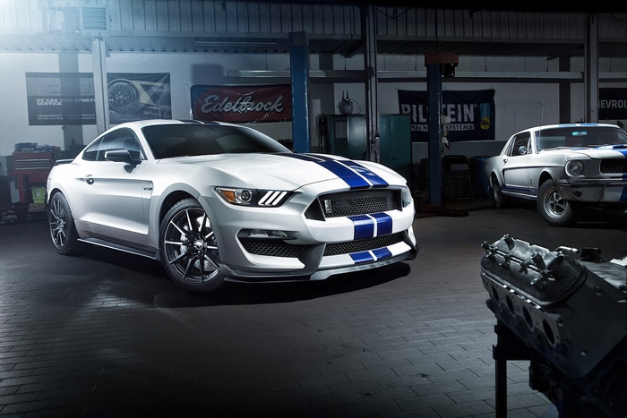 Ford Mustang GT350 and classic Mustang in garage