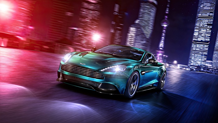 Aston Martin Vanquish driving through a city at night