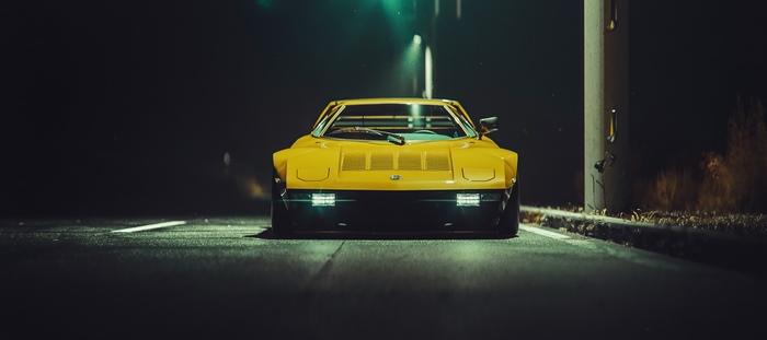Yellow Mazda RX-7 on a dark road