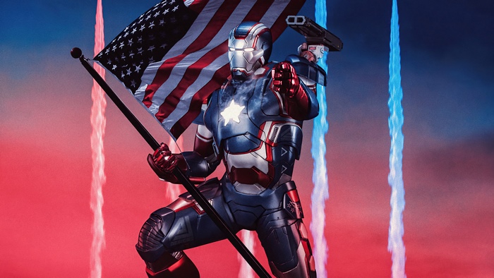 Iron Patriot holding American flag with fireworks