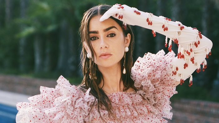 Lily Collins in a ruffled dress with pearl and bead embellishments