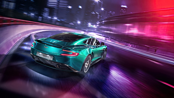 Aston Martin Vanquish driving on a city road at night