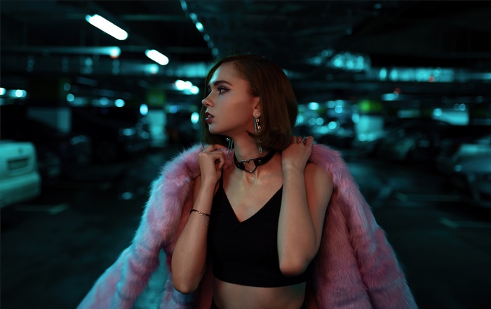 Girl in pink fur jacket in parking lot