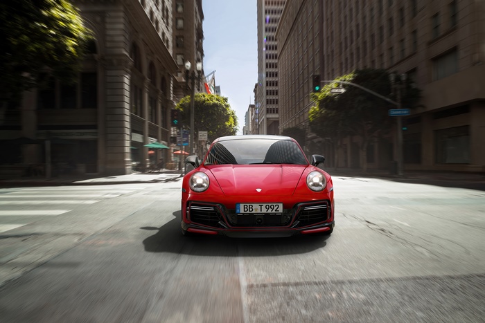Red Porsche 911 driving in city