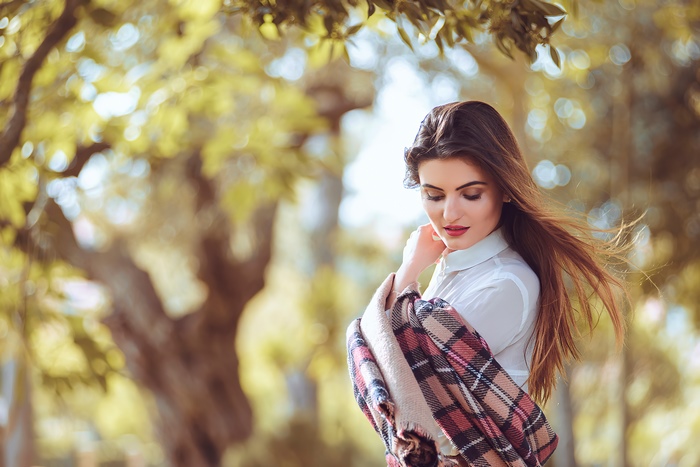 Woman with plaid scarf in park