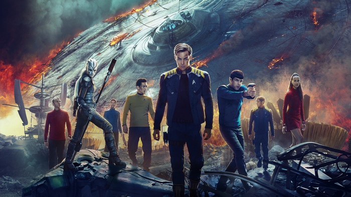 Star Trek Beyond cast in front of a damaged starship