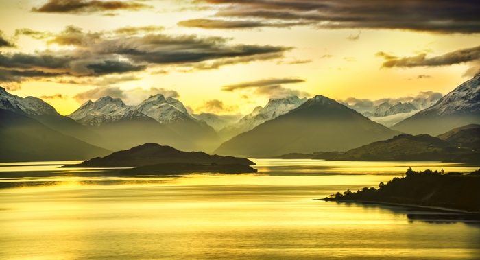 Golden sunset over mountains and lake