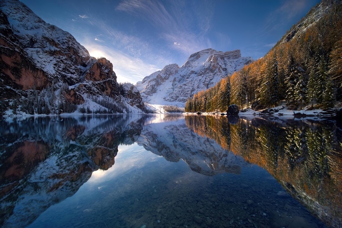 Lake reflection of snow-capped mountains and autumn trees