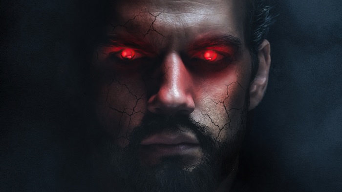 Superman with glowing red eyes and cracked skin