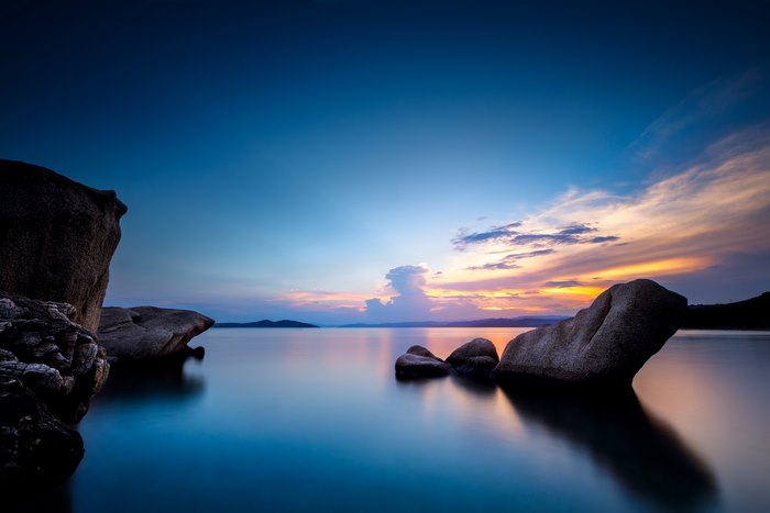 Rocks in a lake at sunset, 4K