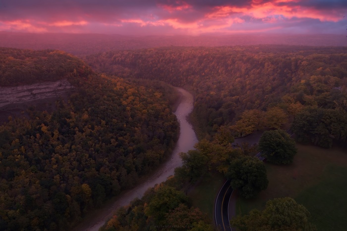 River valley with forest and pink sky