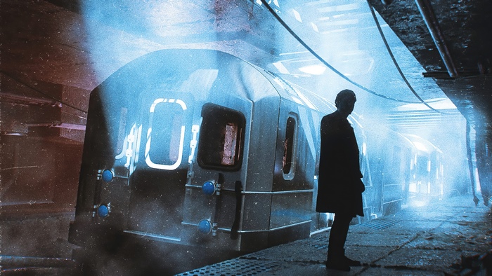 Man standing on subway platform next to train