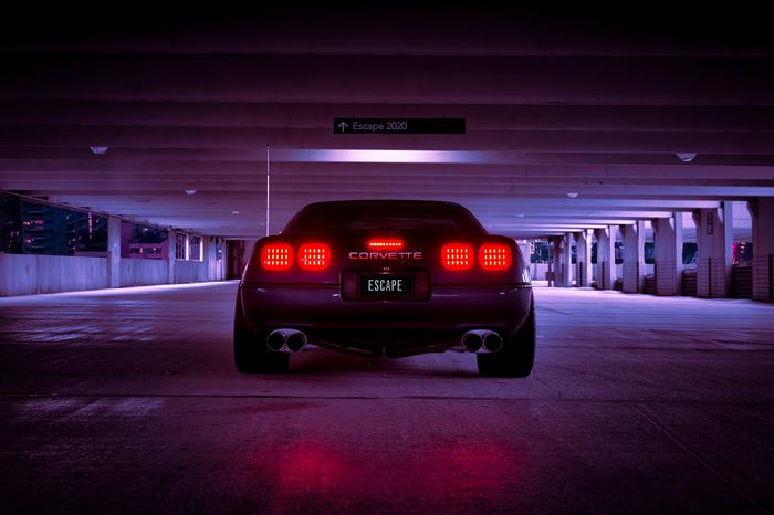 Corvette with ESCAPE license plate in parking garage