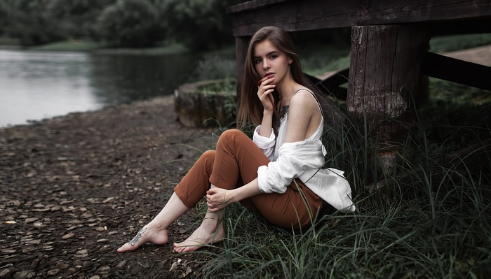Girl Sitting by the Lake in Nature