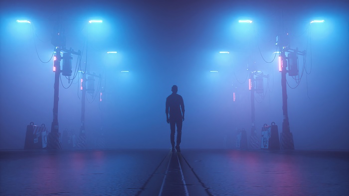 Man walking down a foggy street with streetlights