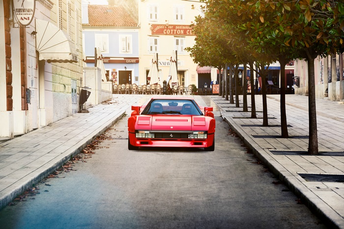 Red Ferrari 288 GTO parked on a European street