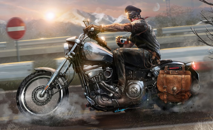 Biker with camera riding motorcycle on road
