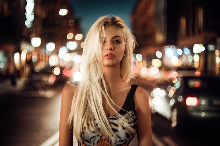 Blonde model in a tiger print dress at night