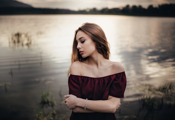 Girl by the lake at sunset