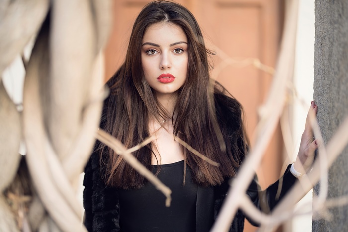 Model in black jacket with red lipstick
