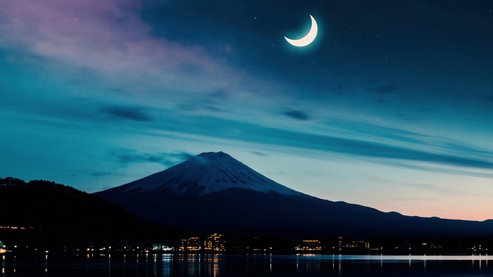 Mount Fuji at night with crescent moon