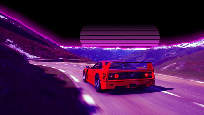 Red Ferrari F40 driving on mountain road at sunset