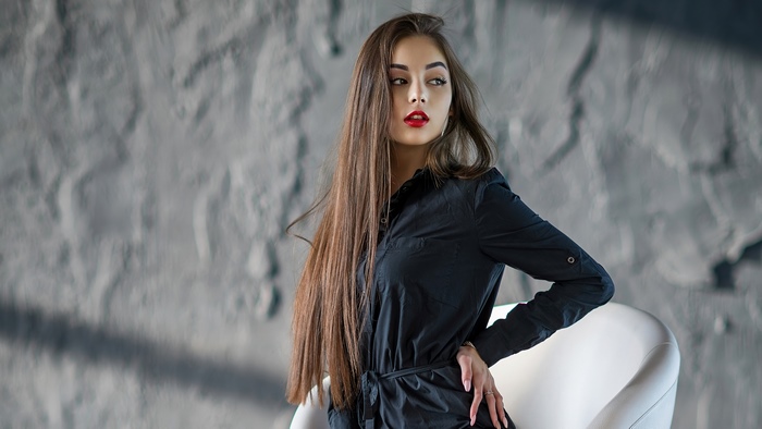 Model in black dress with red lipstick