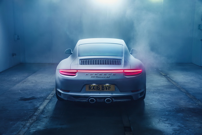 Porsche 911 Carrera S in a smoky garage