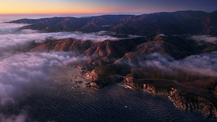 Big Sur coastline with fog and mountains at sunrise