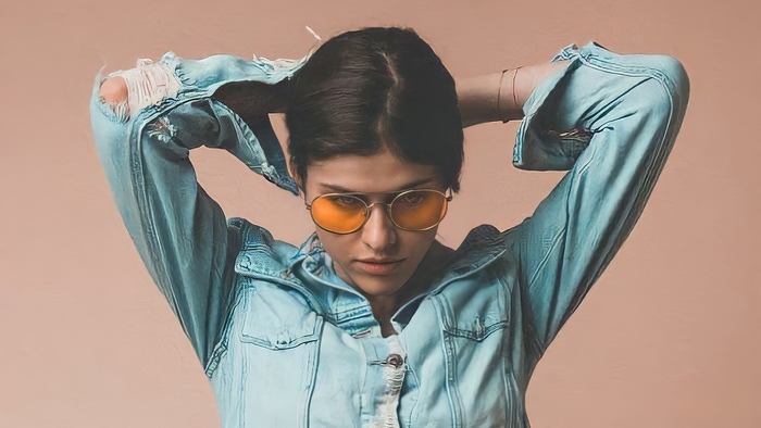 Alexandra Daddario in a denim jacket and sunglasses