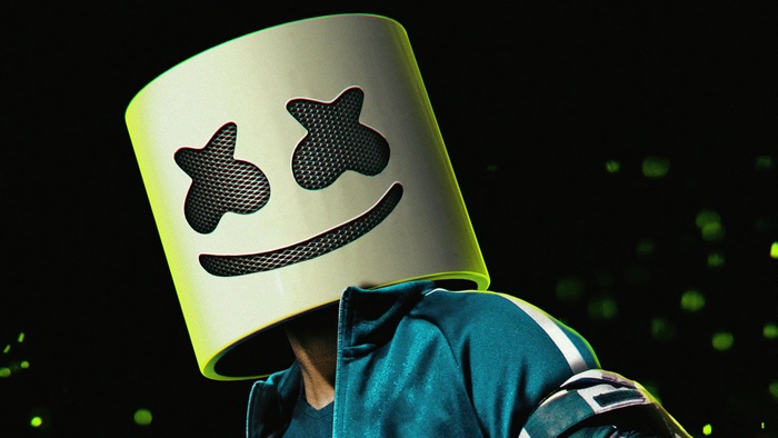 Marshmello wearing his iconic mask and teal jacket