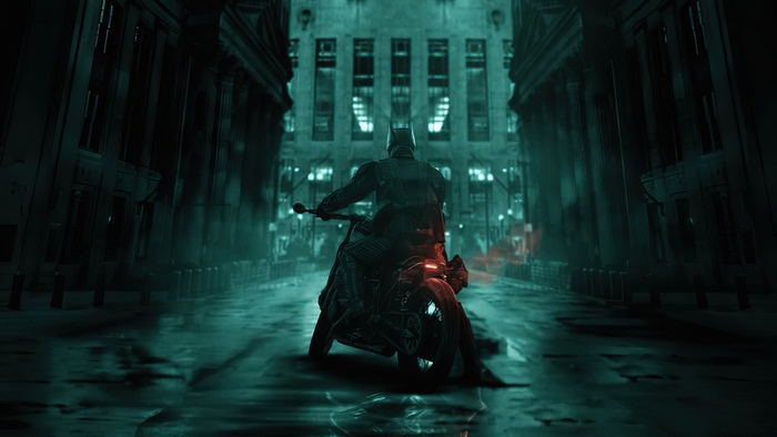 Batman on a motorcycle in a dark city street