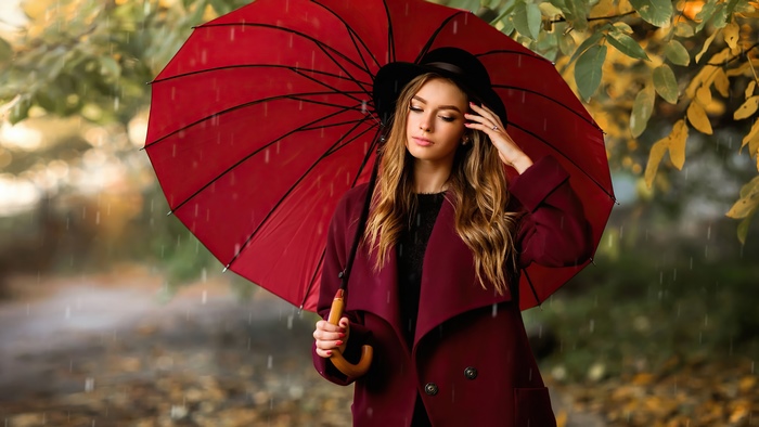 Girl with red umbrella in the rain