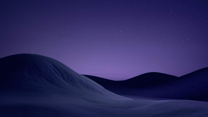 Purple night sky over rolling hills