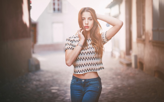 Young woman in patterned crop top and jeans