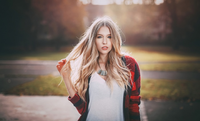 Blonde girl in a red plaid cardigan