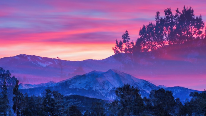 Mountains and trees during a colorful sunset 4K