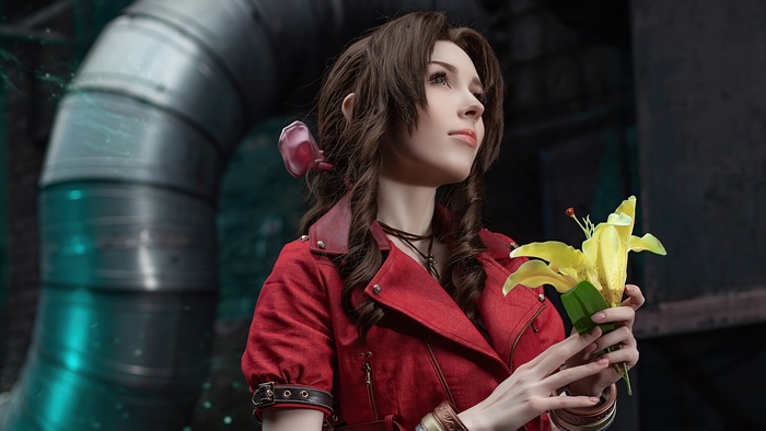 Aerith Gainsborough from Final Fantasy cosplay holding a yellow lily