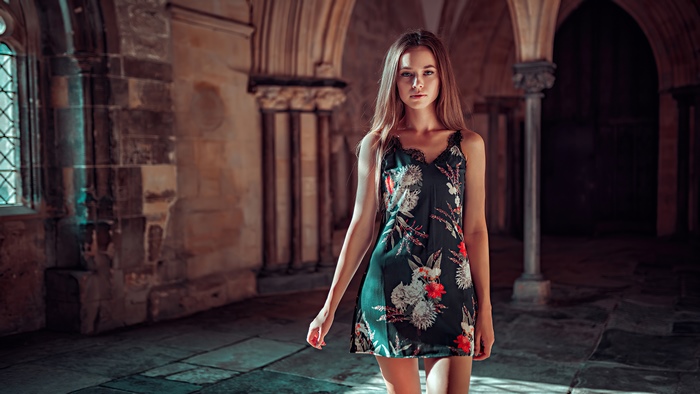 Model in floral dress in ancient hall