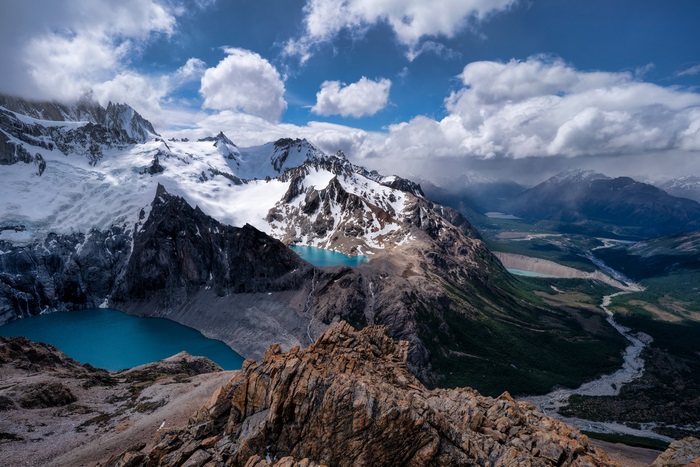 Snow-capped mountains with turquoise lakes and river valley