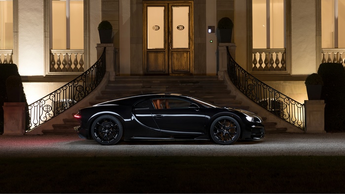 Black Bugatti Chiron parked in front of a mansion