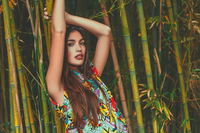 Paula Riba in colorful dress among bamboo