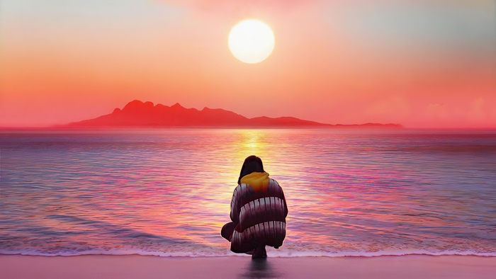 Person watching sunset over the ocean