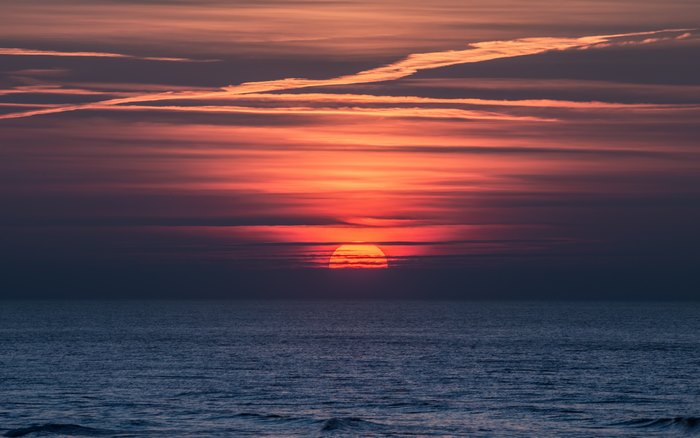 Sunset over the ocean with clouds